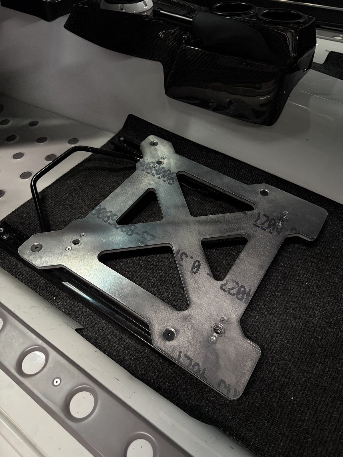 Prototype seat mount bracket test-fit in a race car